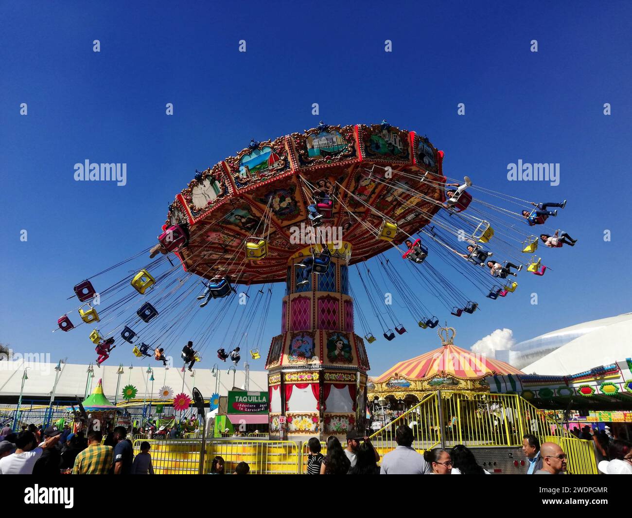 LEON, MEXICO. JAN 21. (EDITORIAL USE ONLY) Visitors rides flying chair ...