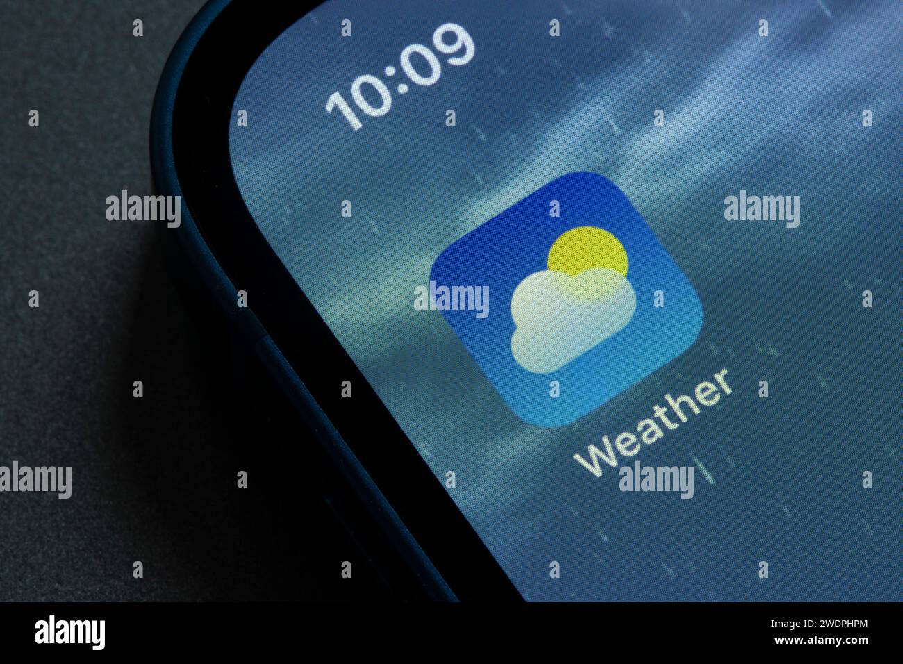 Weather app icon is seen on an iPhone. Weather is a weather forecast app developed by Apple, Inc., available on iOS since the release of the iPhone ... Stock Photo