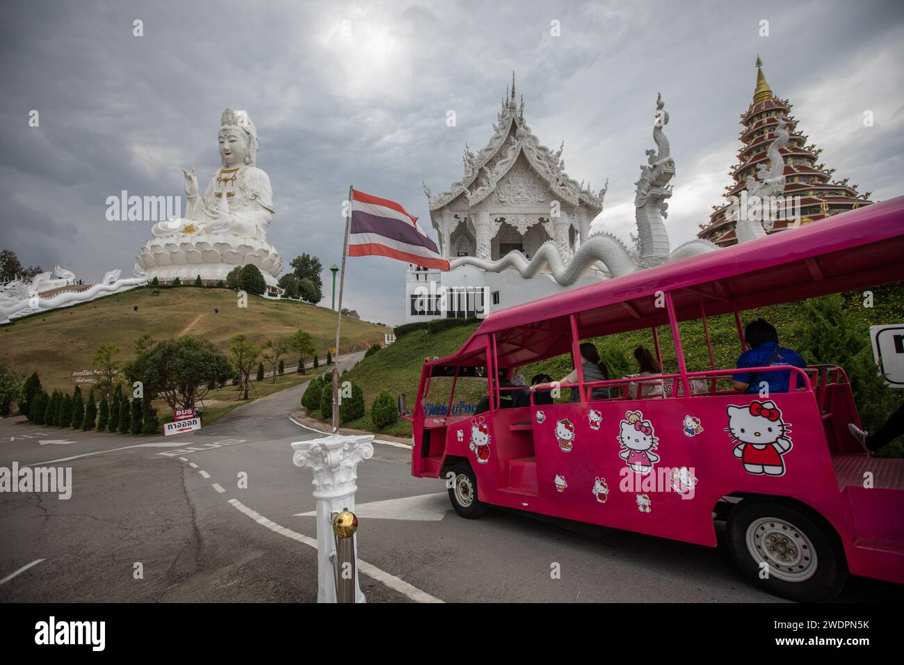 Chiang Rai, Thailand. 17th Jan, 2024. An ''Hello Kitty'' pink mini bus carry tourists at the Wat Huay Pla Kang Temple. The ''Wat Huay Pla Kang'', also known as 'Big Buddha of Chiang Rai'', is well known for its enormous white statue of Guanyin (In Chinese Mythology, The Goddess of Mercy). The recently built temple is a mix of Thai Lanna and Chinese styles located on a hill in the rural area North of Chiang Rai town. (Credit Image: © Guillaume Payen/SOPA Images via ZUMA Press Wire) EDITORIAL USAGE ONLY! Not for Commercial USAGE! Stock Photo