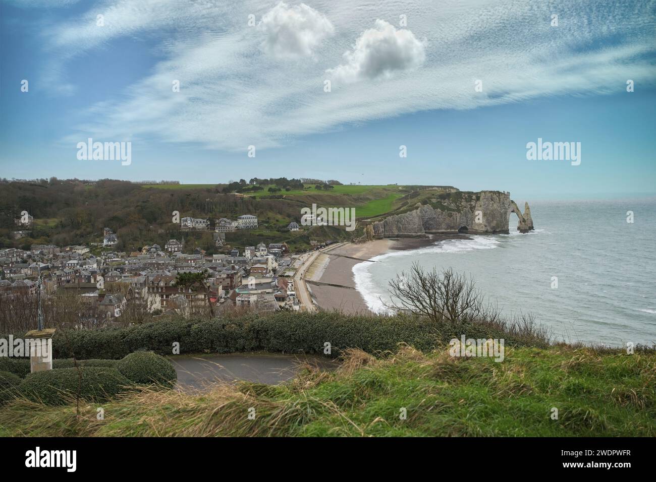 A scenic view of Etretat in Normandy, with cliffs and on pebble beach ...