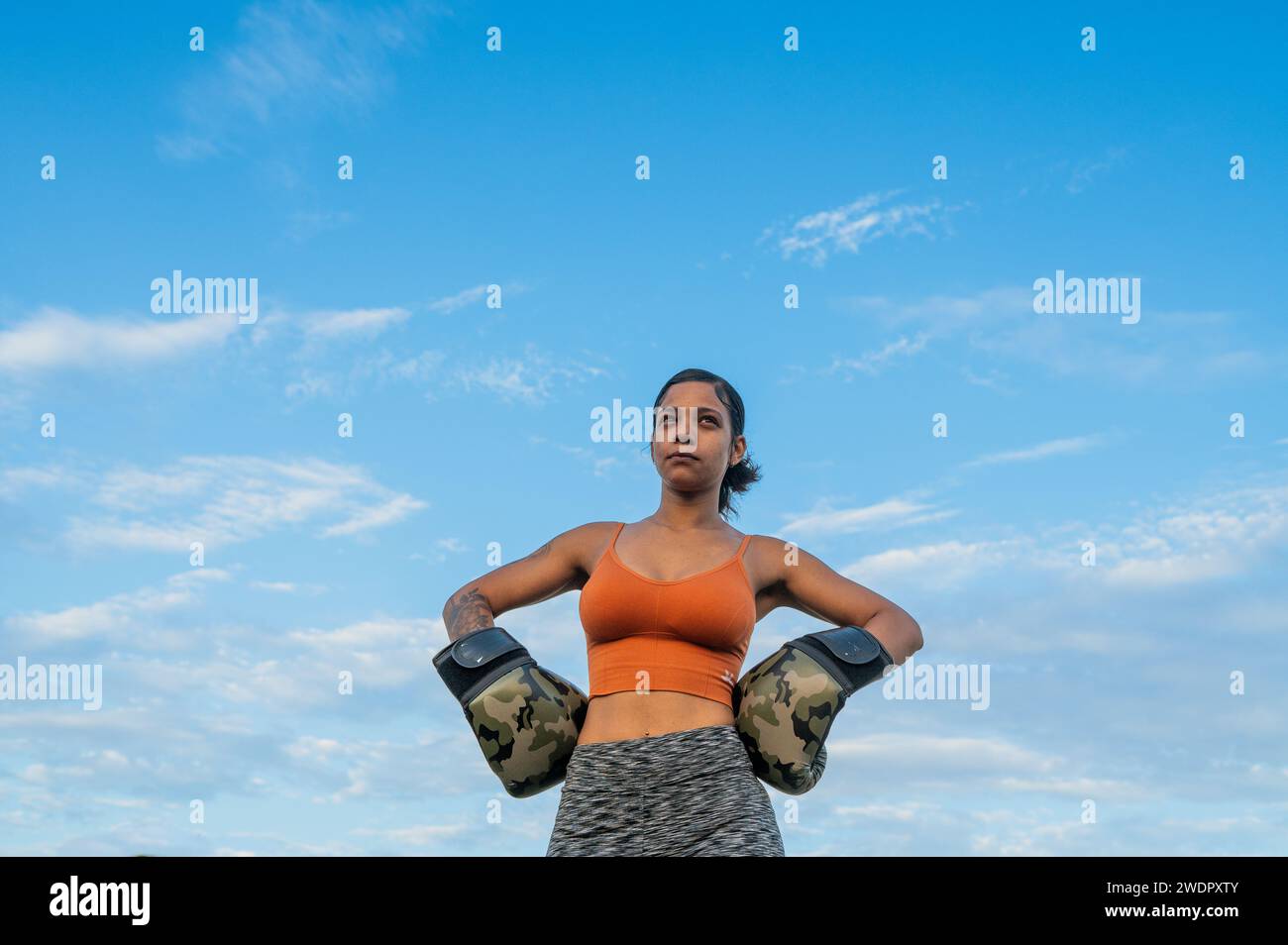Woman seen wearing boxing gloves Stock Photo
