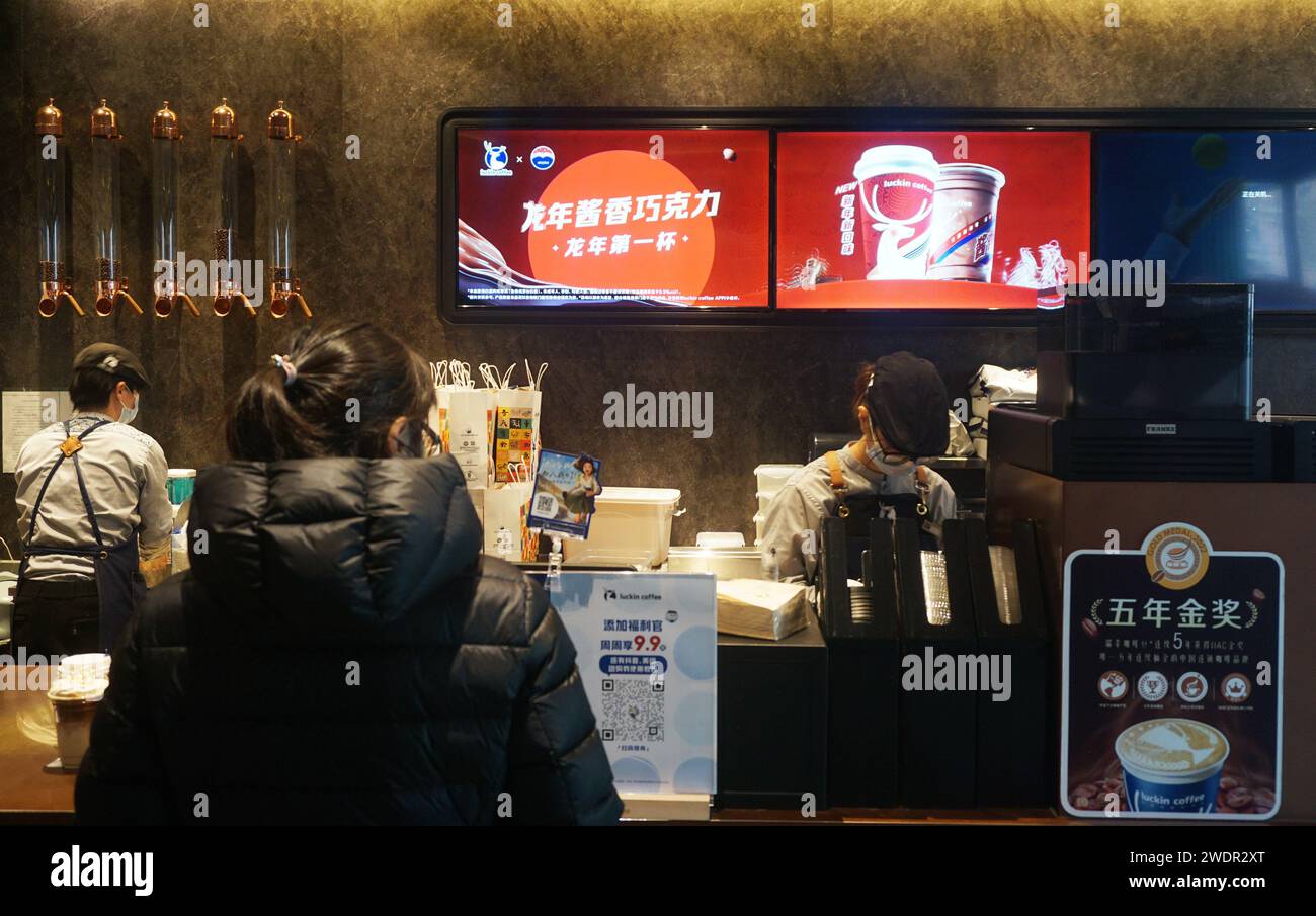 HANGZHOU, CHINA - JANUARY 22, 2024 - A customer buys a 'Year of the Dragon Sauce Chocolate' drink launched by Kweichow Moutai and Luckin Coffee in a L Stock Photo