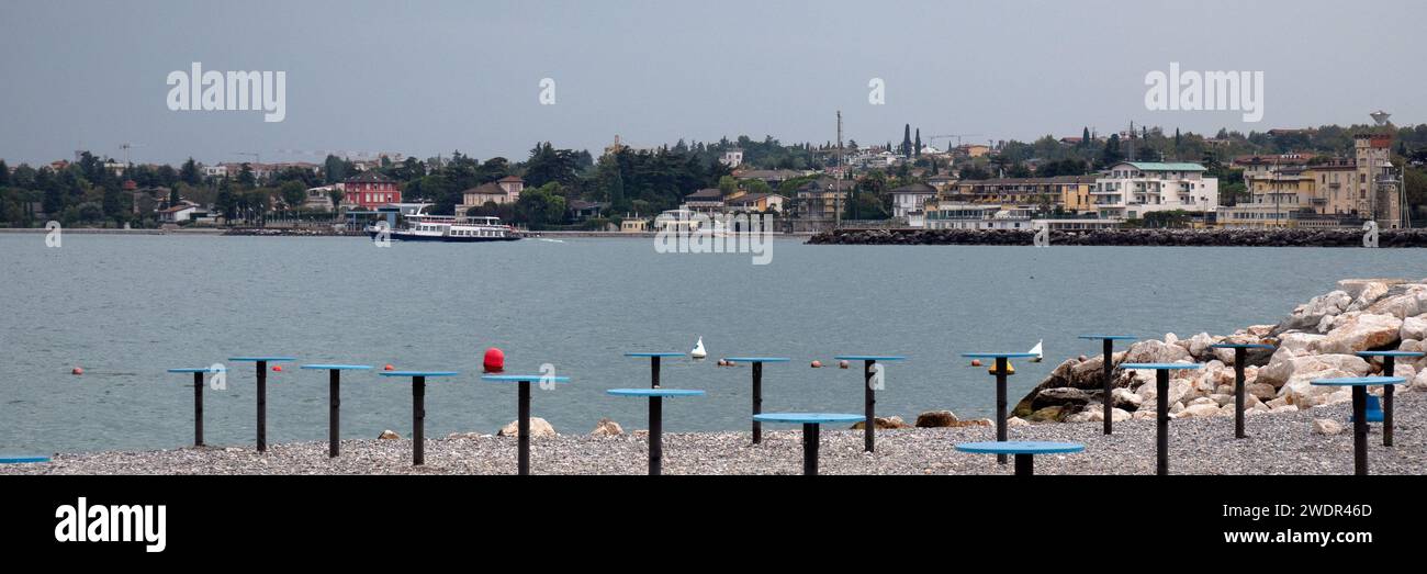 DESENZANO DEL GARDA, ITALY - SEPTEMBER 22, 2023:   Panorama view of a community area on the beach Stock Photo