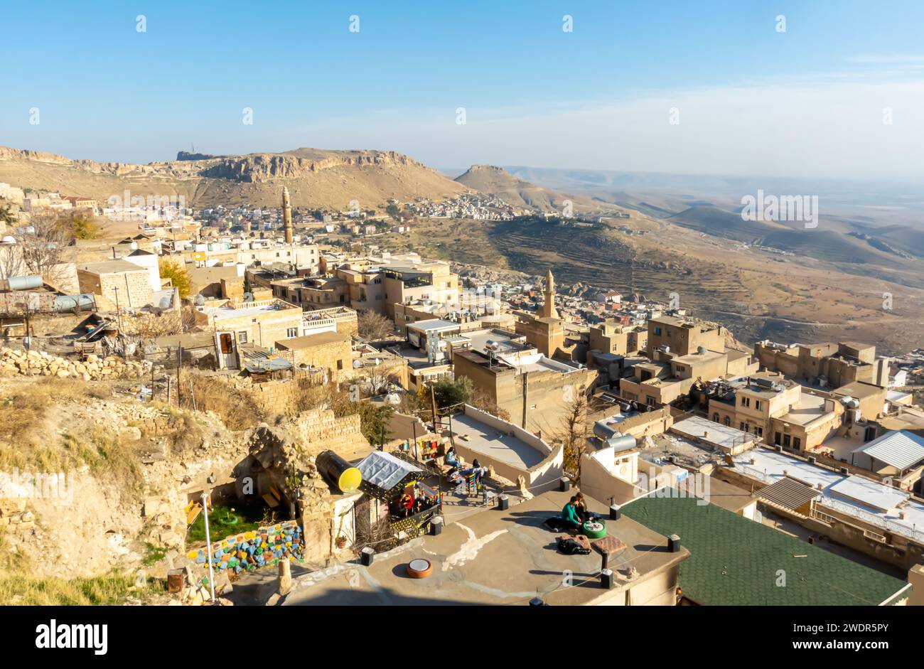 Rooftops of Mardin, roofs of central Mardin, the tourist destination in Southeastern Turkey. People at the rooftop cafes in Mardin Stock Photo
