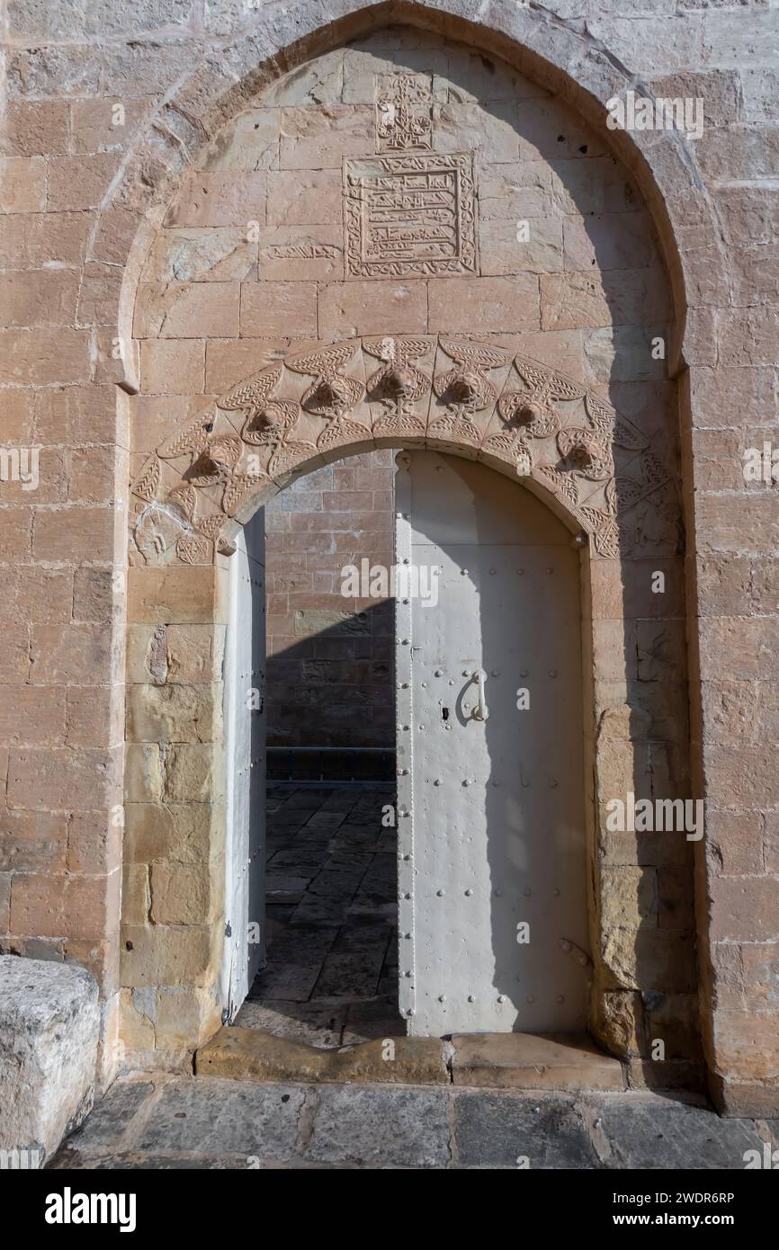 The door with inscriptions to Forty Martyrs Church (Kırklar Kilisesi) Christian church in Mardin,  Turkey. 6th century Stock Photo