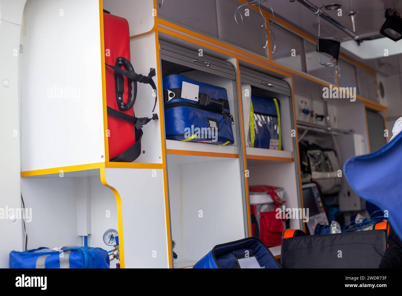 Inside of an ambulance showing medical supplies and storage ...