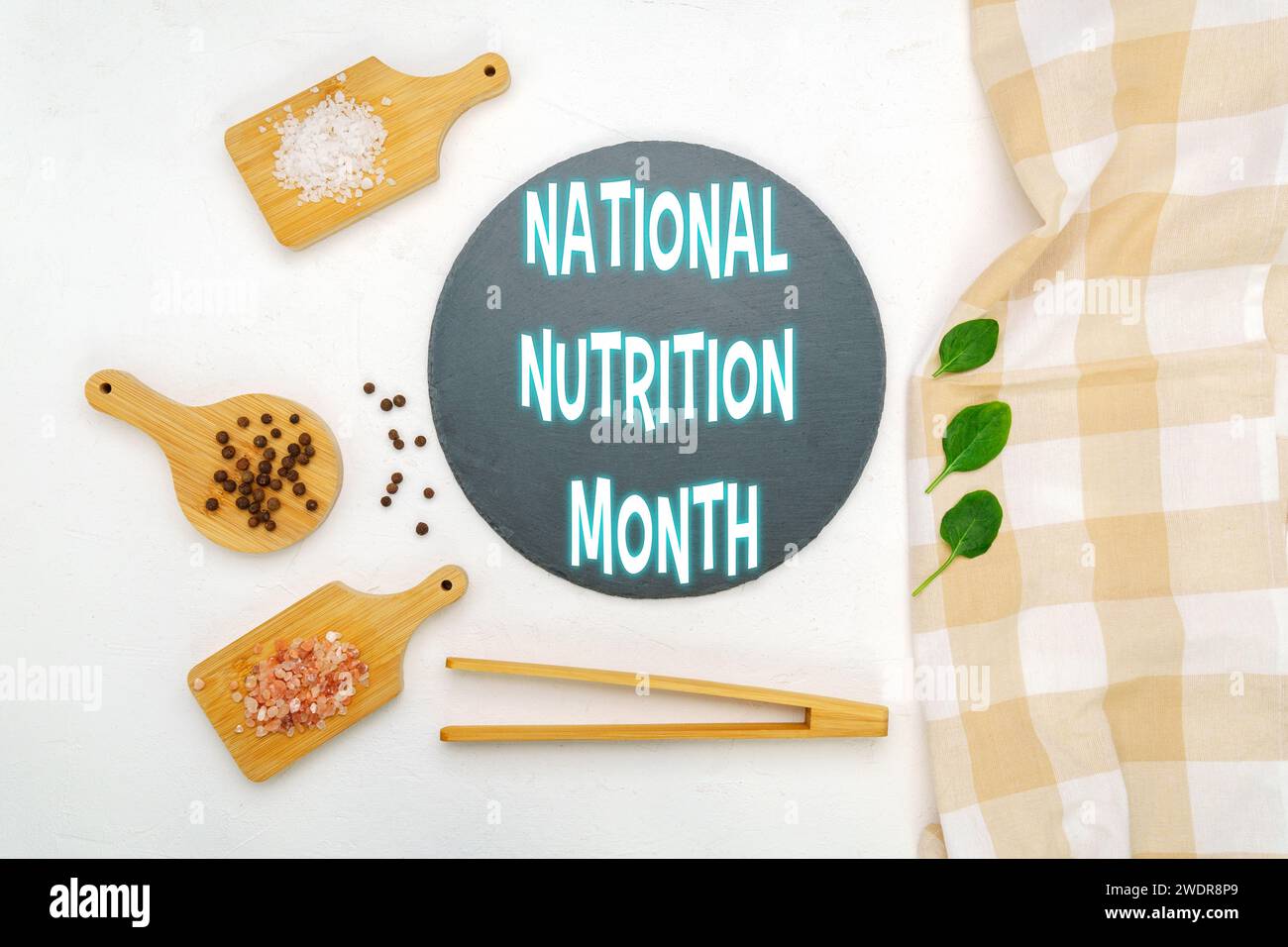 A creatively arranged display featuring text announcing National Nutrition Month by natural food elements. Stock Photo