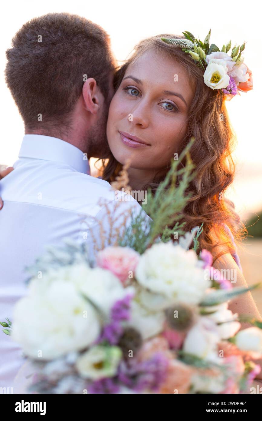 the bride and groom posing at sunset Stock Photo - Alamy