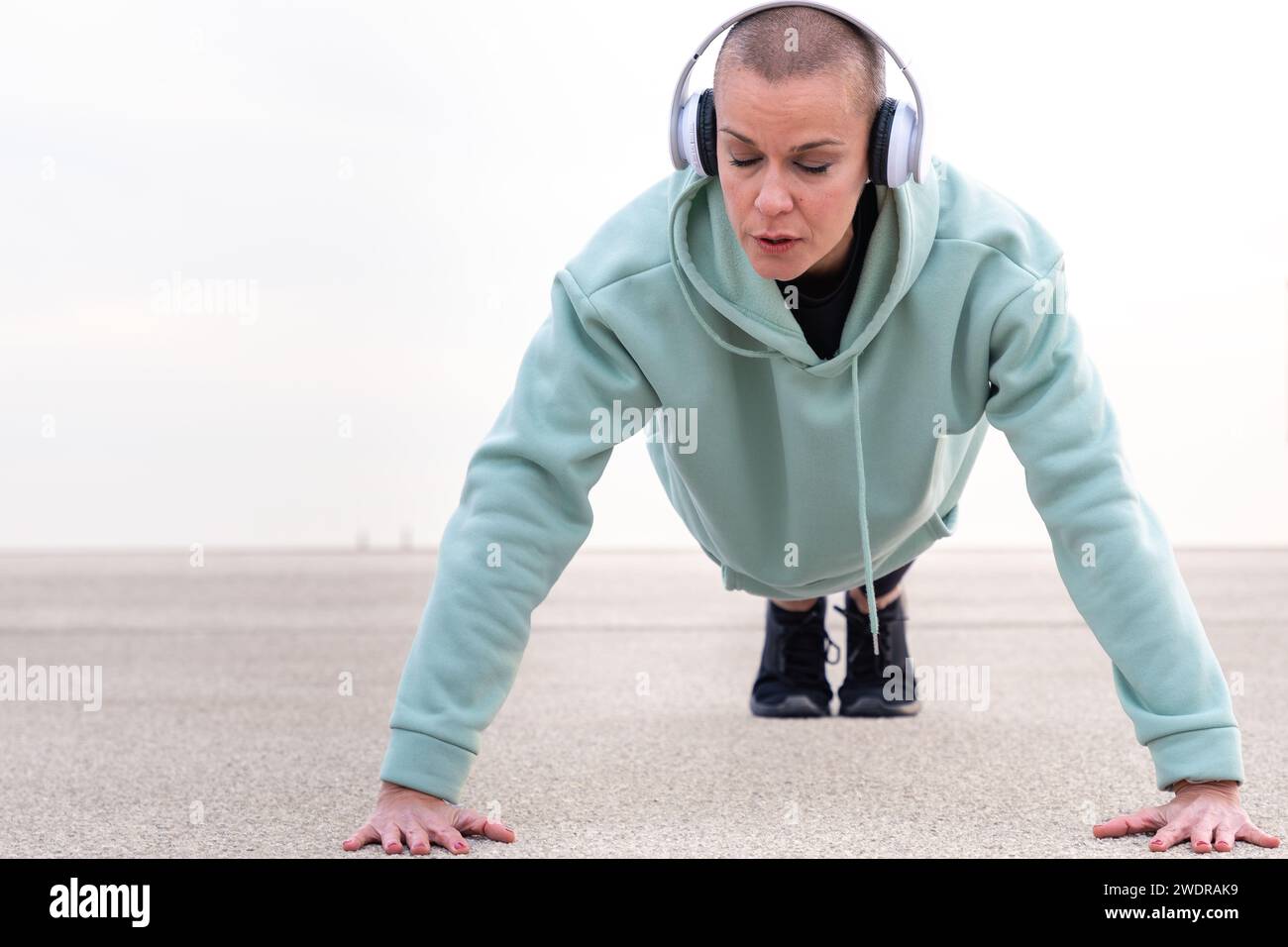 Active and fit woman athlete doing push-ups outdoors. Stock Photo