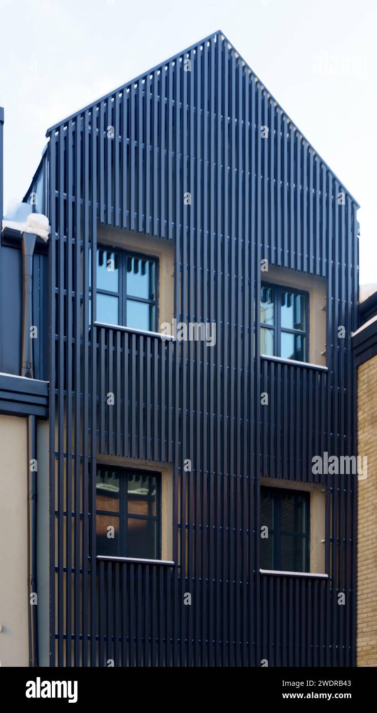 Metal facade trim with dark aluminum panels. Modern house facade and