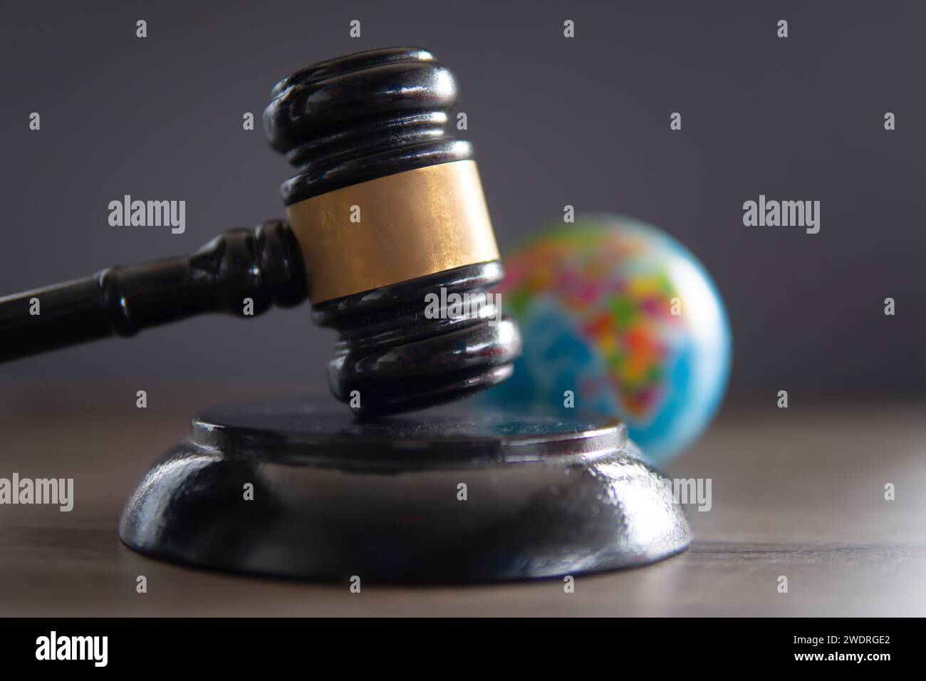 Closeup image of judge gavel and world globe on table. International law concept. Stock Photo