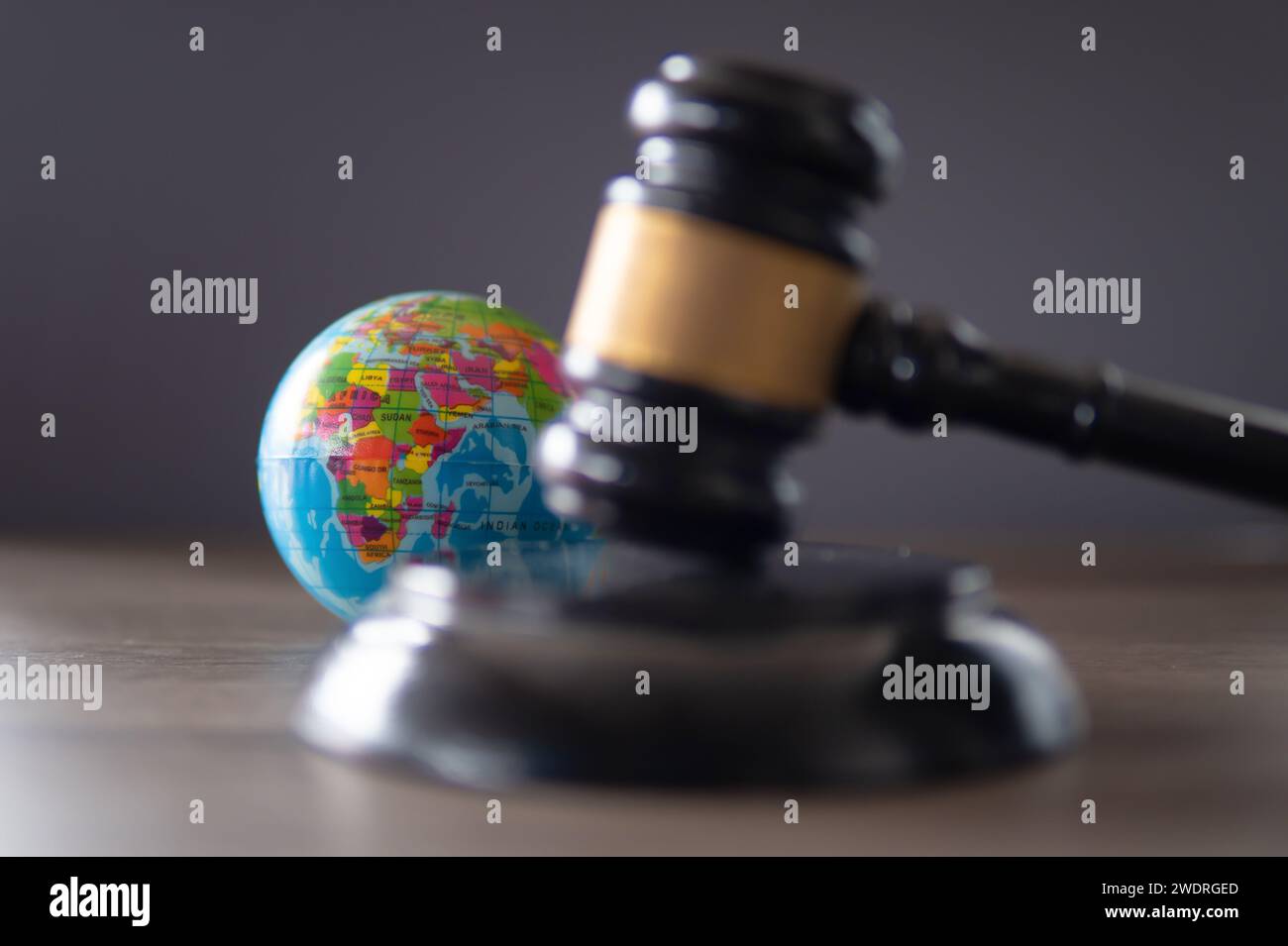 Closeup image of judge gavel and world globe on table. International law concept. Stock Photo