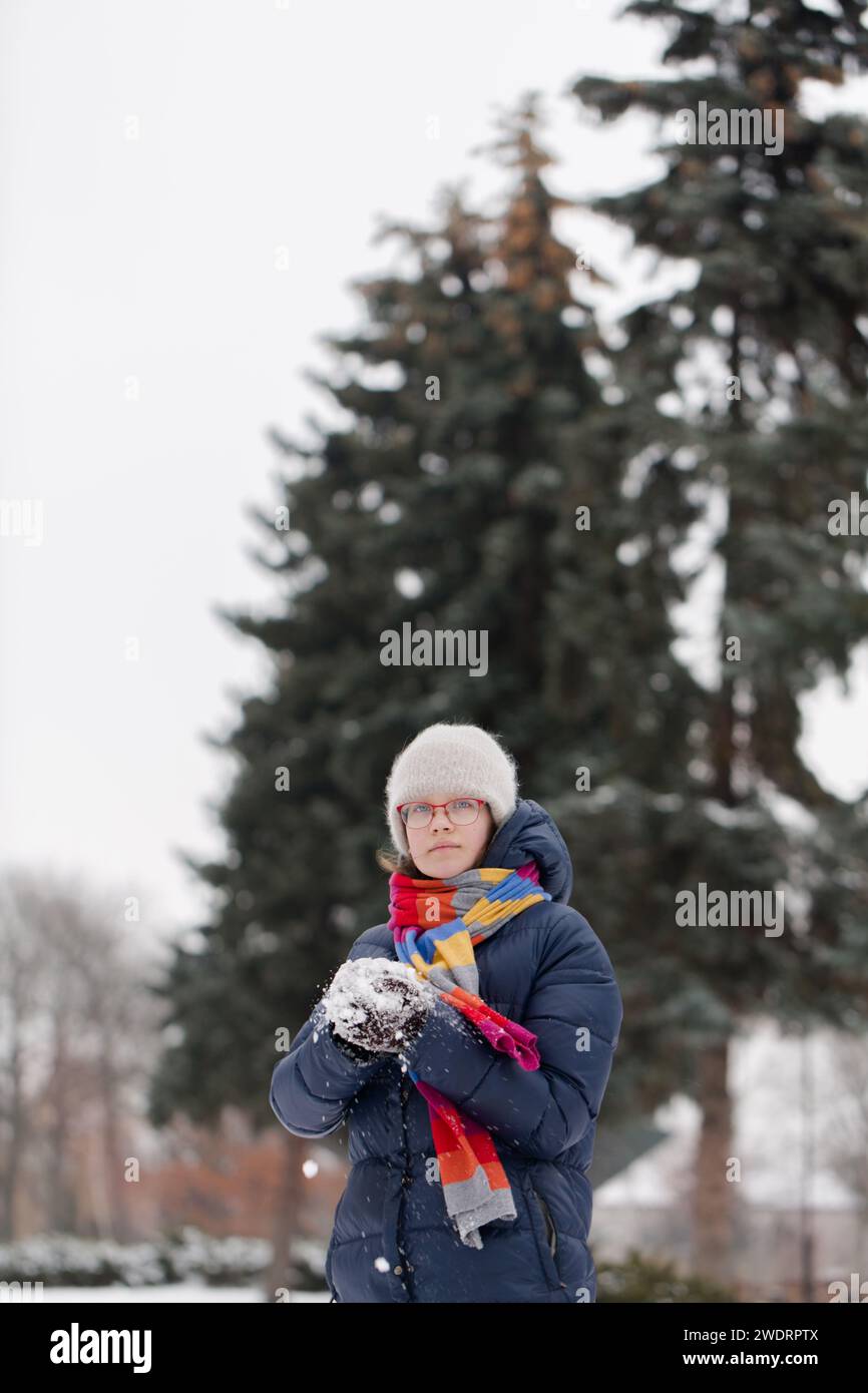 A teenage girl is making a snowball Stock Photo