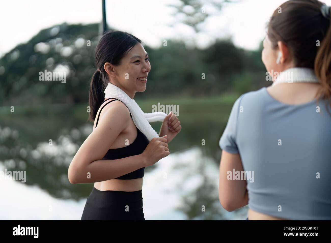 female friend go to exercise together at village park in evening, working out for health Stock Photo