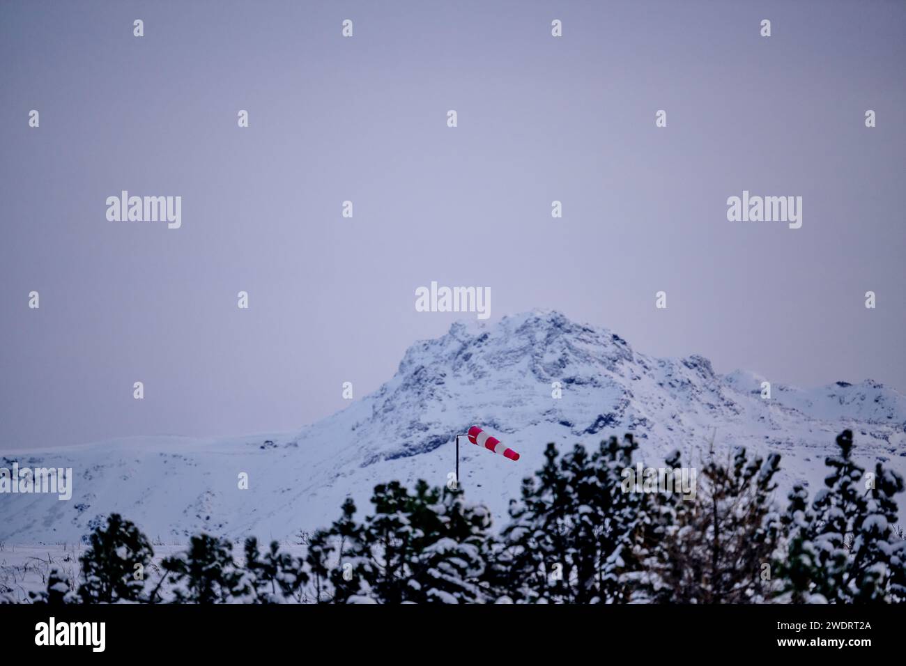Mountain ridge covered in snow with windbag Stock Photo