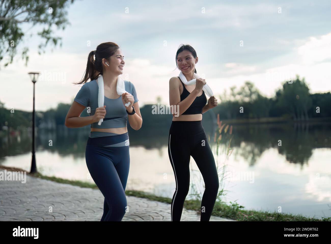 female friend go to exercise together at village park in evening, working out for health Stock Photo