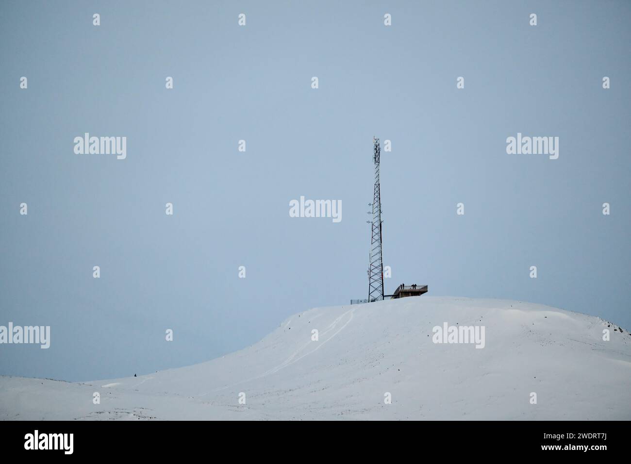 Antenna mast on snowy mountain top in winter Stock Photo