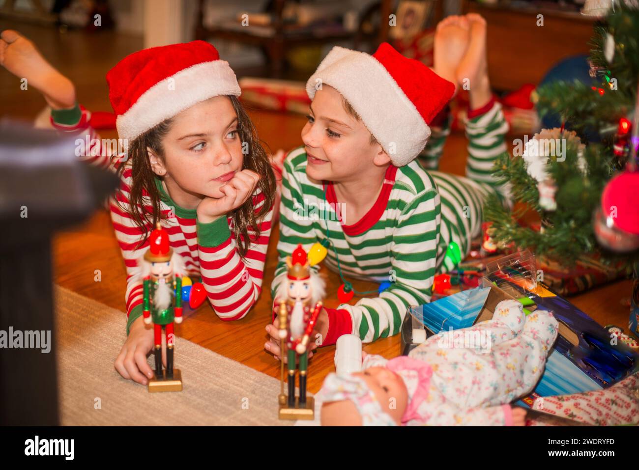 Twins  goof around the christmas tree Stock Photo
