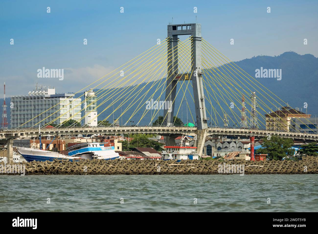 Boats in Manado port and Soekarno Bridge in provincial capital of Sulawesi's far north, Manado, North Sulawesi, Indonesia, Southeast Asia, Asia Stock Photo