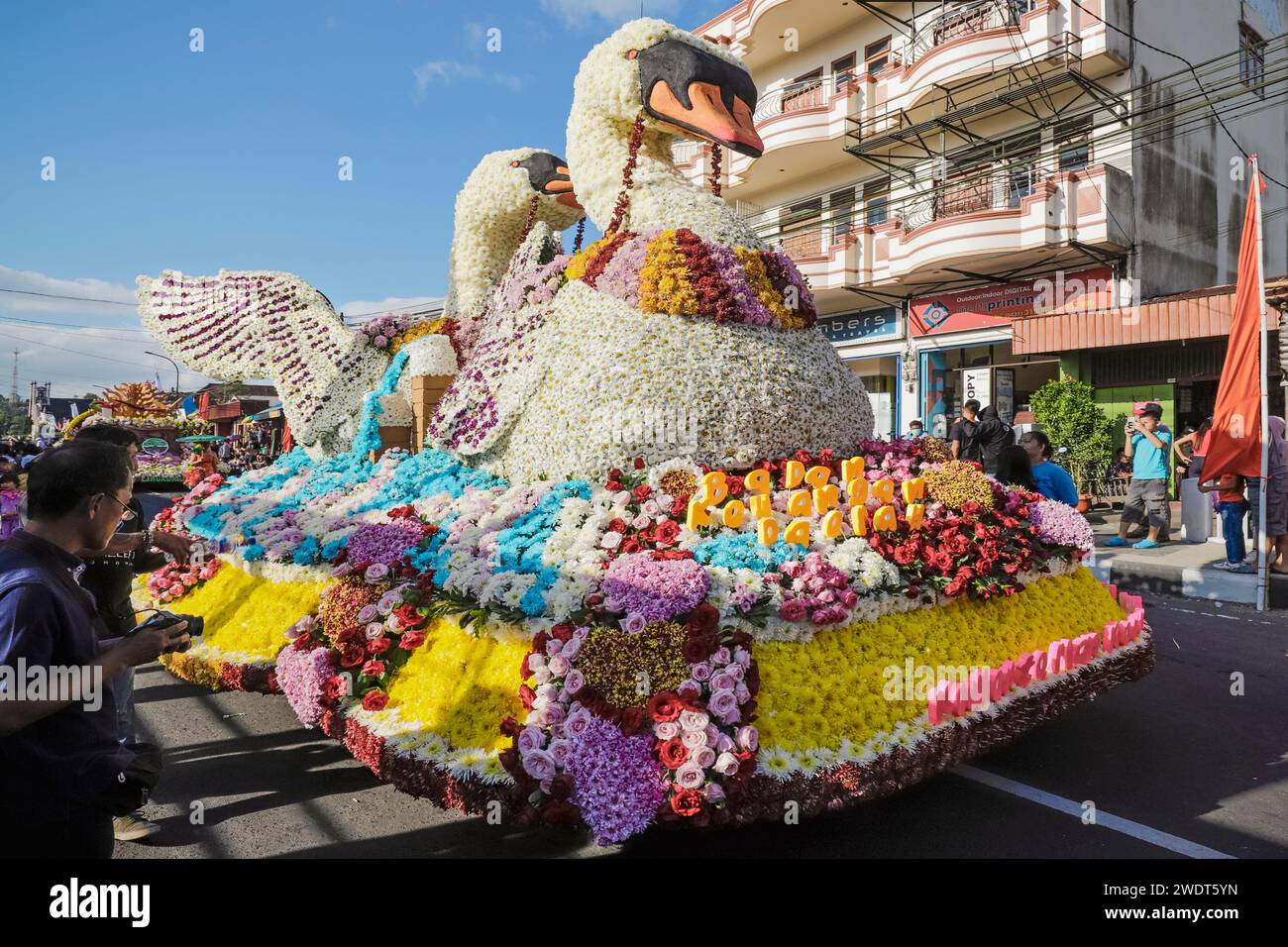 Float with large flower swans at the annual Tomohon International Flower Festival parade in city that is the heart of national floriculture Stock Photo