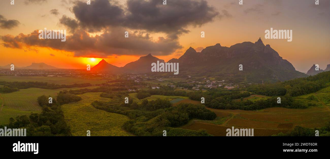 View of golden sunset behind Long Mountain and patchwork of green fields, Mauritius, Indian Ocean, Africa Stock Photo