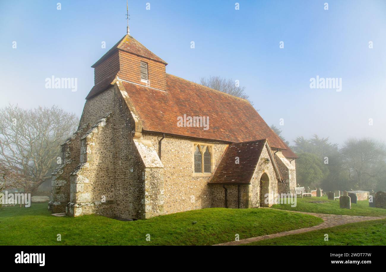 The 11th century Church of St. Mary The Virgin on a foggy winter morning, Friston, South Downs National Park, East Sussex, England, United Kingdom Stock Photo