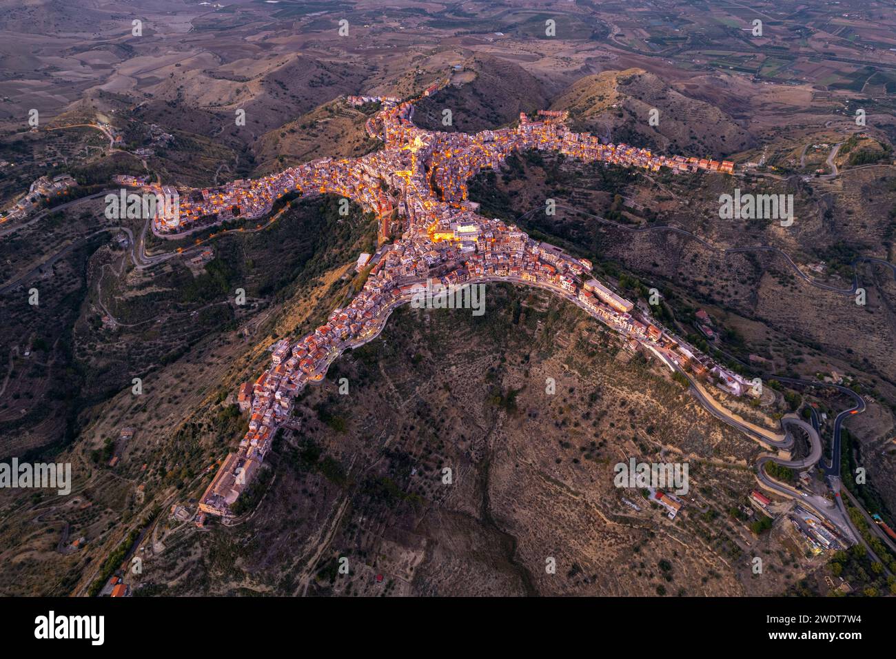 Aerial view of Centuripe, the human-shaped or star-shaped town, seen from above at dusk, Centuripe, Enna province, Sicily, Italy, Mediterranean Stock Photo