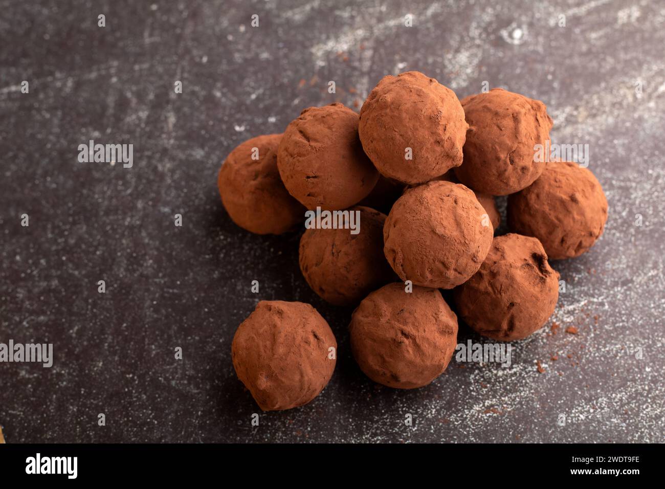 Horizontal photography showcasing handmade chocolate truffles. This gourmet confectionery is a delightful blend of Perfect for those with a taste for Stock Photo