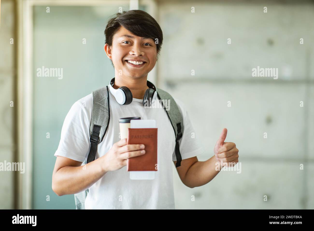 Happy excited young asian man holding passport, showing thumb up Stock ...