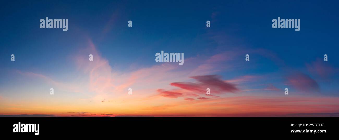 Dramatic colorful sky with soft clouds at sunset. Stock Photo