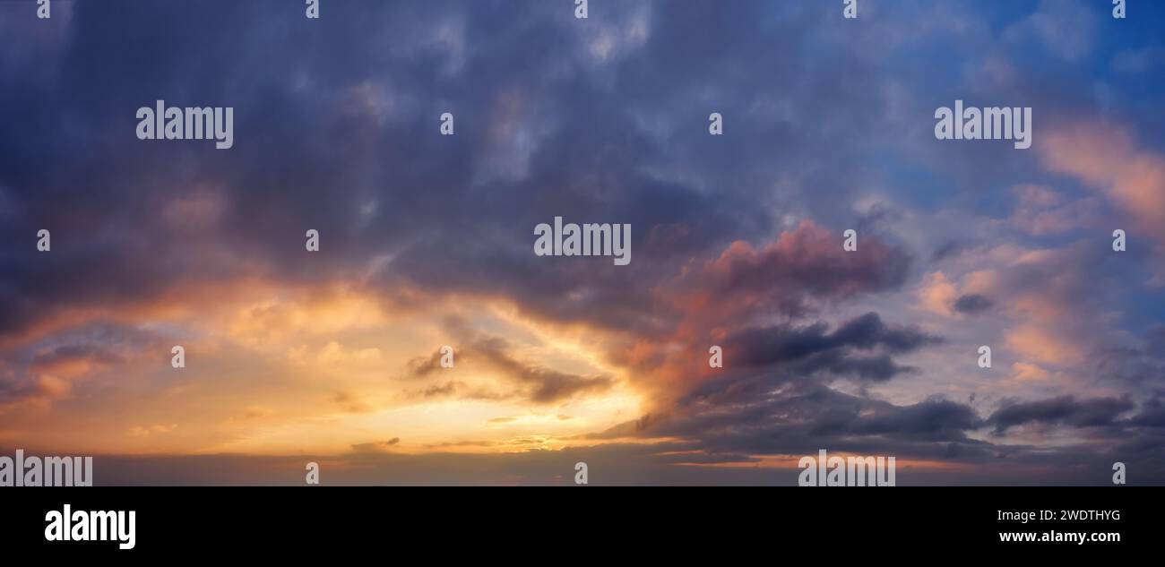 Dramatic sky with dark clouds during sunset. Stock Photo