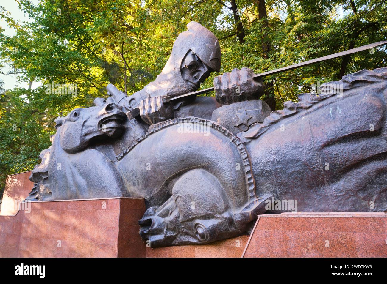 At the left, the part of the memorial with an 'Oath' theme, a soldier leading horses. At the Memorial of Glory in Panfilov park in Almaty, Kazakhstan. Stock Photo