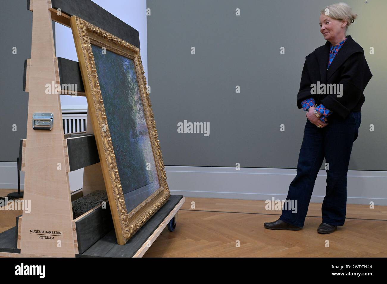 Potsdam, Germany. 22nd Jan, 2024. Ortrud Westheider, Director of the Museum Barberini, looks at the newly acquired painting 'The Mill of Limetz' (1888) by the painter Claude Monet. Credit: Michael Bahlo/dpa/Alamy Live News Stock Photo