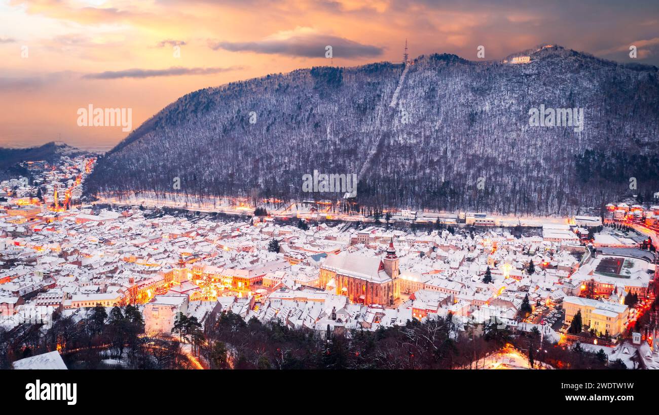 Brasov, Romania. Snowy morning view of the old town, Christmas season aerial drone flight in Transylvania. Stock Photo