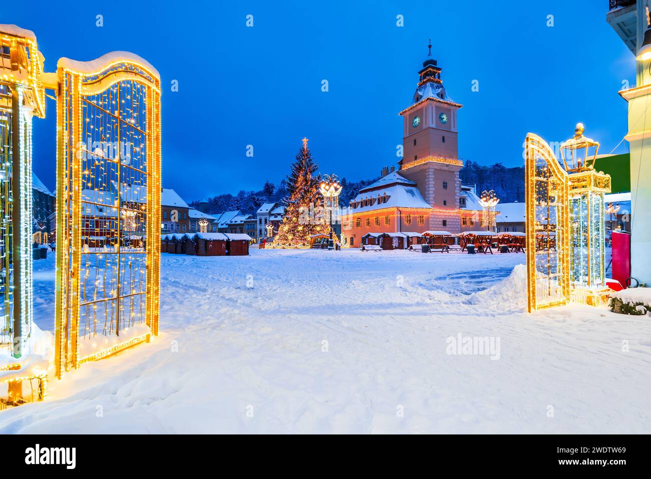 Brasov, Romania. Night illuminated scenic Main Square with Christmas Market and Santa Claus tree, winter holidays. Stock Photo