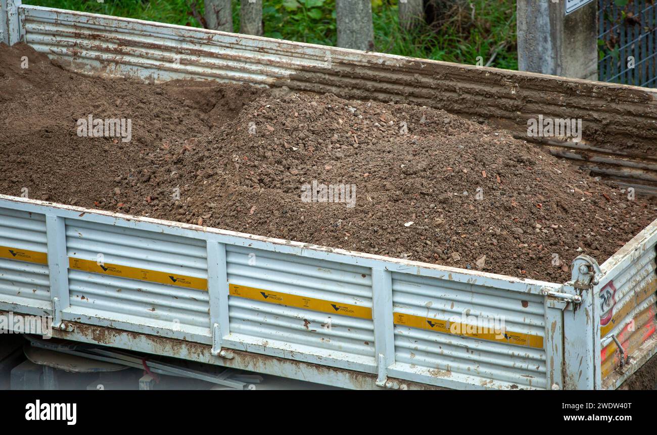Tipper truck with excavated earth for water works Stock Photo