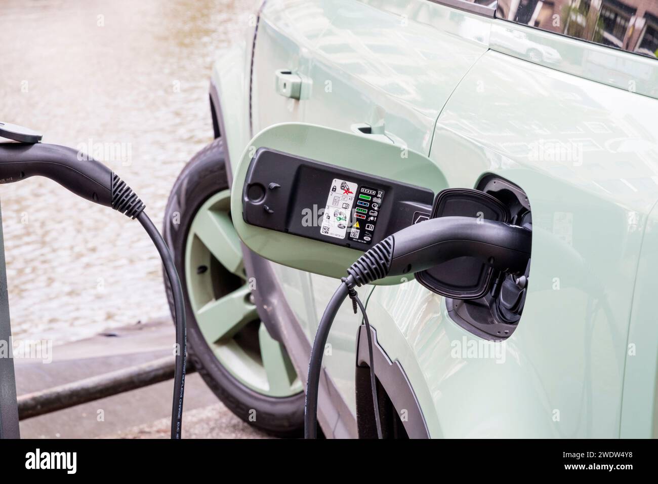 Charging port of an electric plug-in hybrid Land Rover Defender charging at a public charging point in Amsterdam, Holland. Stock Photo