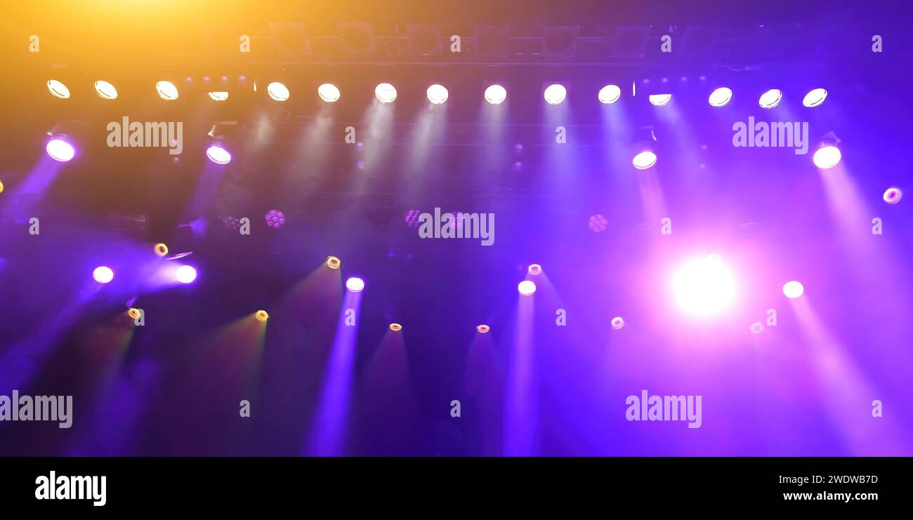 glowing purple atmospheric abstract background of concert spotlights with light and Mist during the show or concert Stock Photo