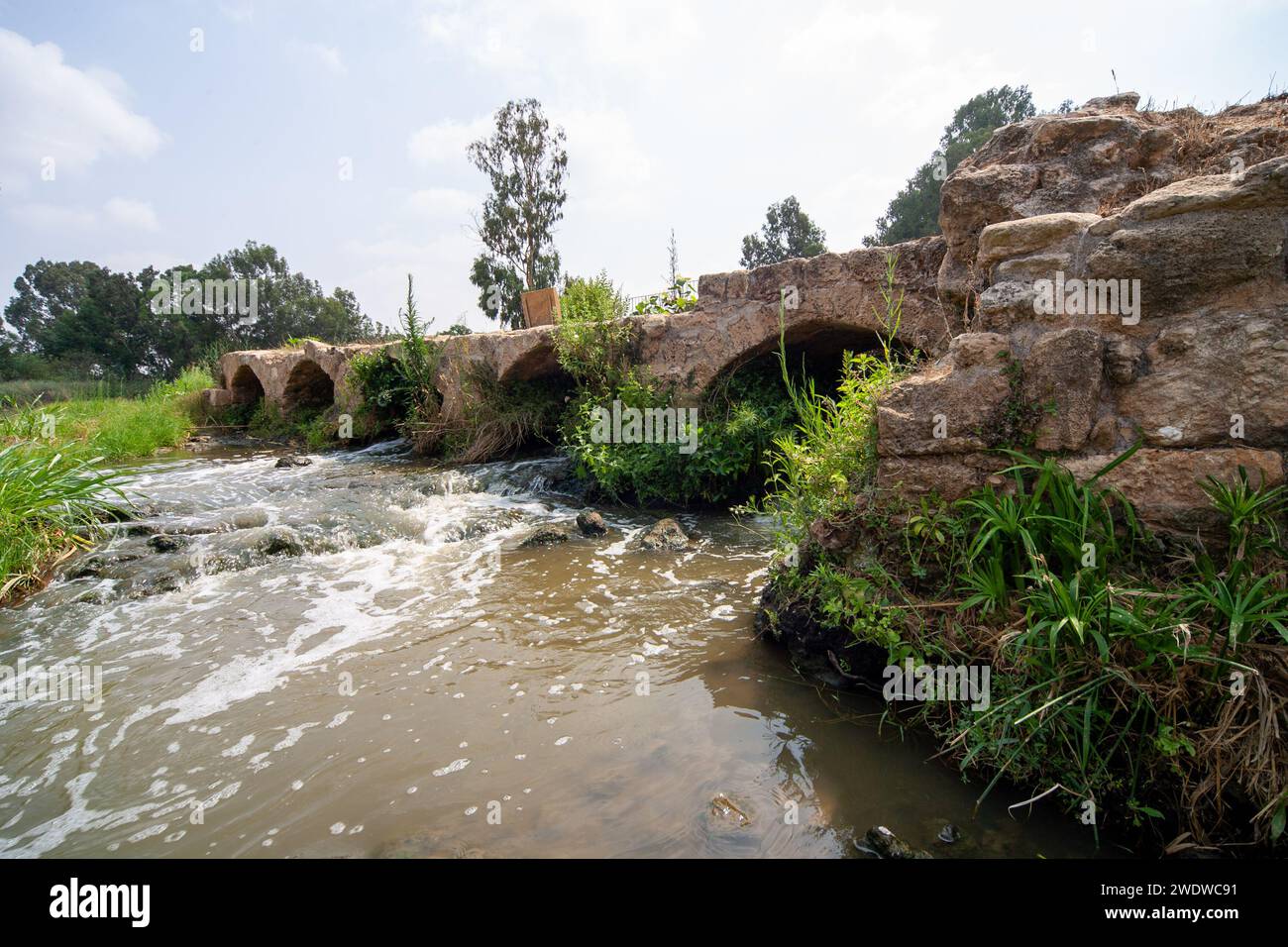Ten Mills ancient bridge and water powered flour mills on the Yarkon river, Tel Aviv, Israel Stock Photo