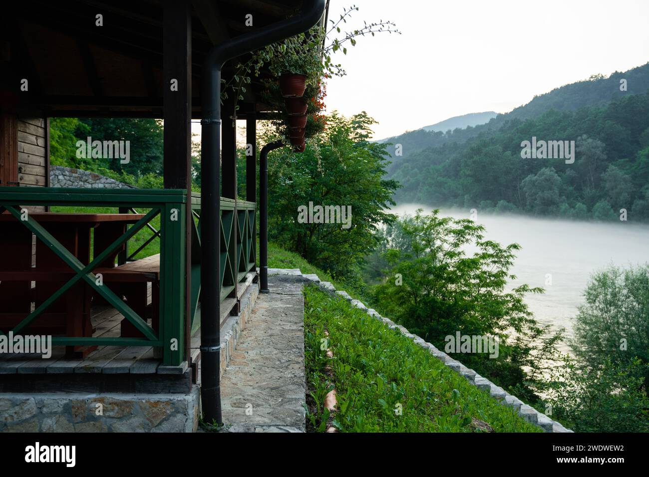 Porch of a wooden house in the forest on the river bank Stock Photo - Alamy