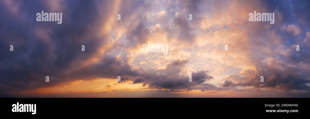 Picturesque panorama of sky with clouds during sunset. Background for design. Stock Photo