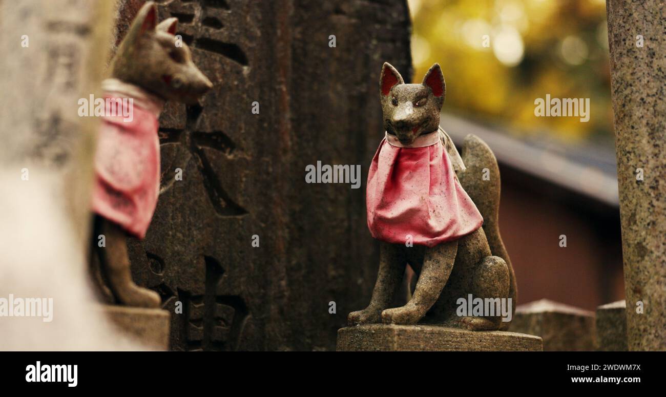 Fox statue at Shinto shrine in forest with spiritual history, Japanese