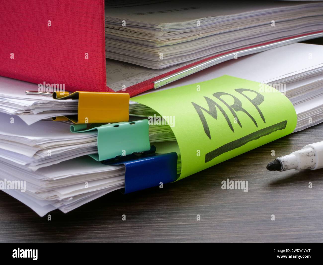 Stack of papers and label MRP Material requirements planning. Stock Photo