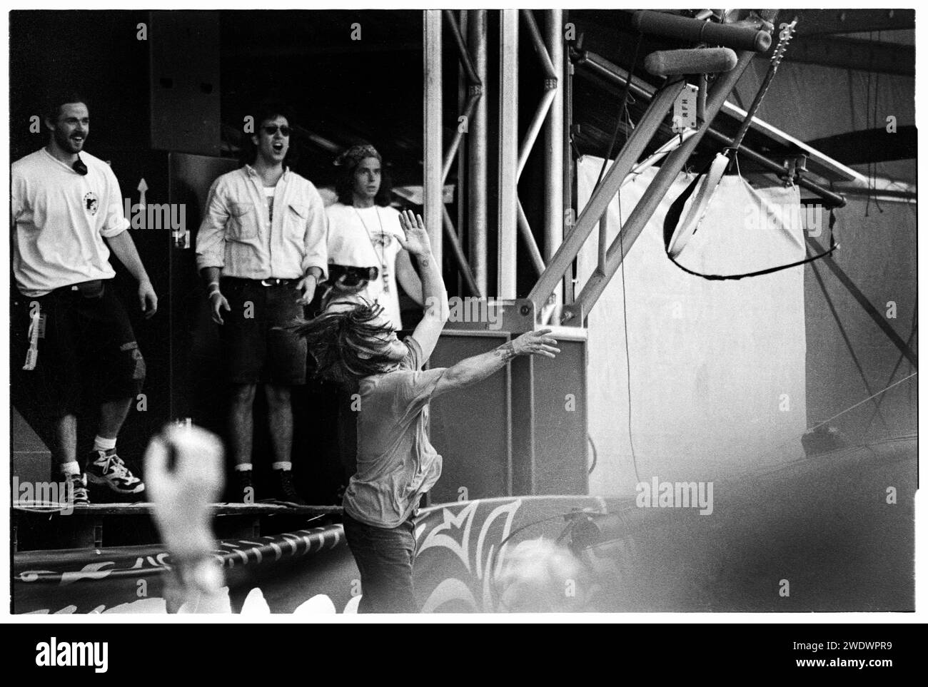 SHANNON HOON, STAGE DIVING, GLASTONBURY, 1995: Shannon Hoon (1967-1995) of the American band Blind Melon throws his guitar and  jumps into the crowd from the Main Stage at Glastonbury Festival, Pilton, England, on 24 June 1994. Photo: ROB WATKINS. INFO: Blind Melon, an American rock band formed in 1990, gained fame with their hit 'No Rain.' Led by the late Shannon Hoon, their mix of alternative rock and psychedelic elements, heard in albums like 'Blind Melon,' marked their brief yet impactful presence in the '90s music landscape. Stock Photo