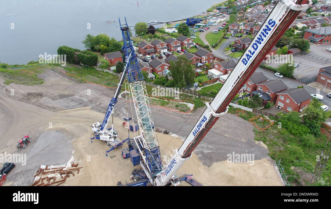 Aerial photography of a heavy Baldwins crane lifting bridge beams into place over Poolstock Lane