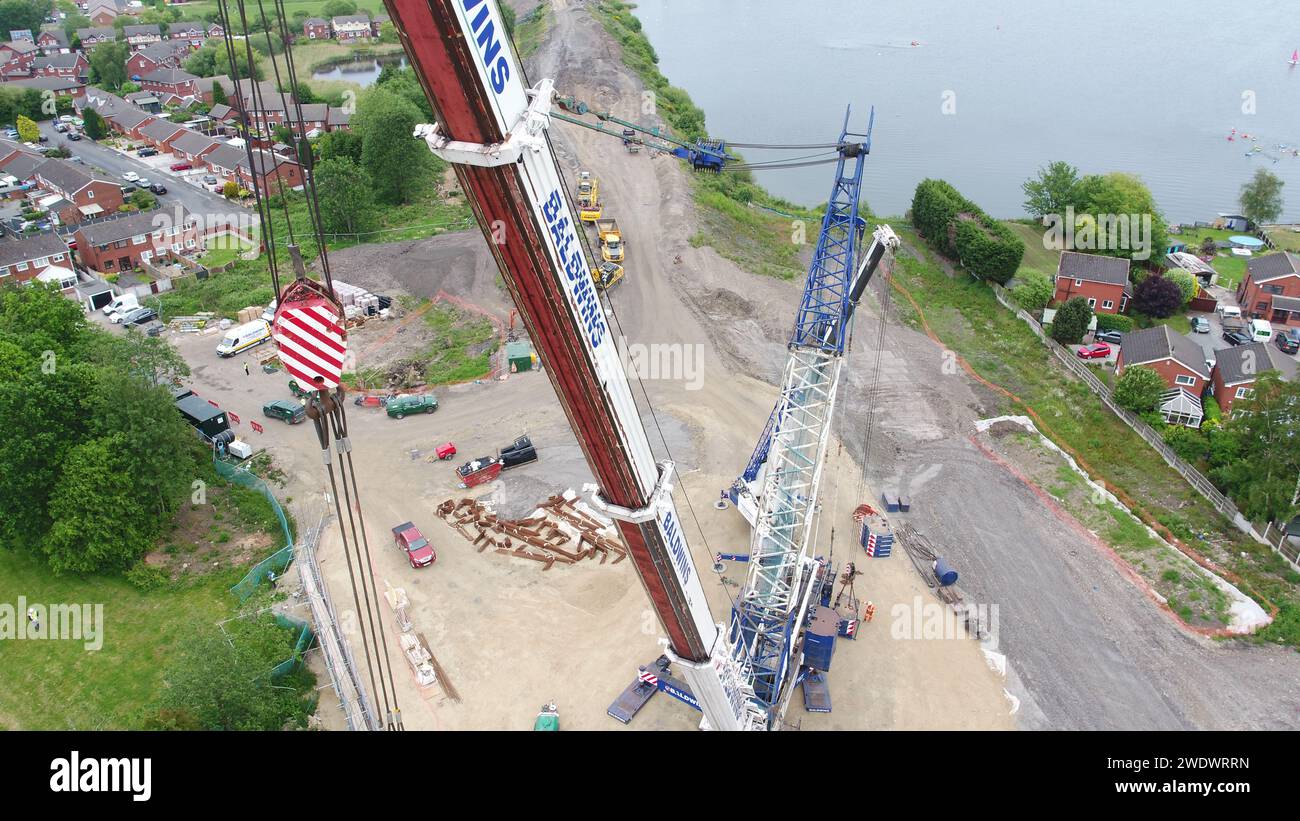 Aerial photography of a heavy Baldwins crane lifting bridge beams into place over Poolstock Lane