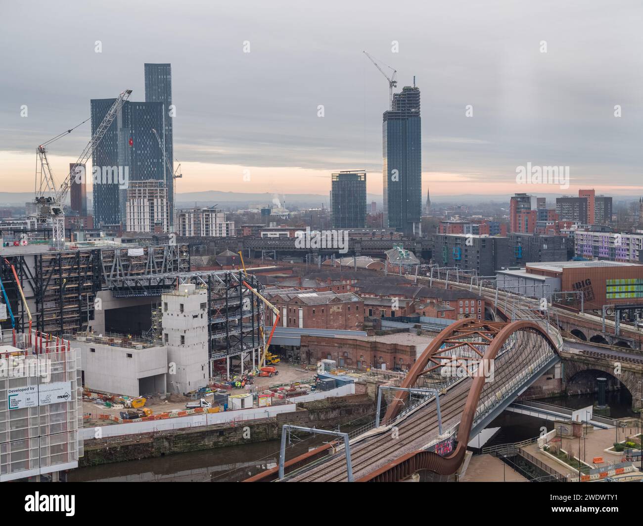 Aerial photo of Ordsall Chord railway line and bridge, with Aviva Studios under construction in Manchester city centre, UK Stock Photo