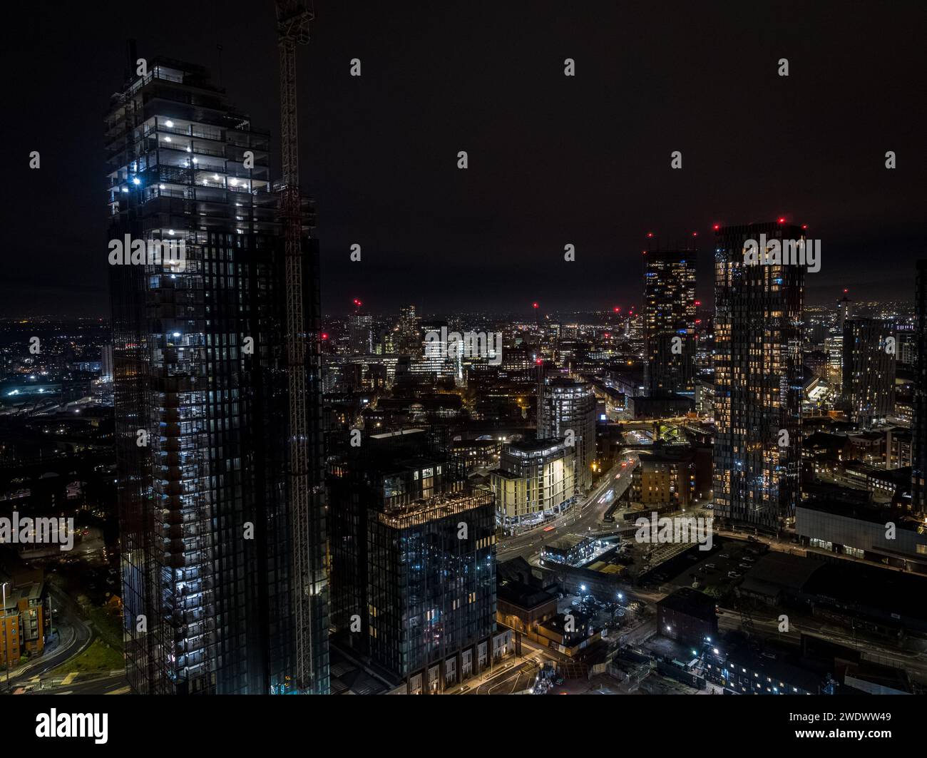 Night time aerial photo of Crown Street residential development under construction with Deansgate Square & Beetham Tower in Manchester, UK Stock Photo