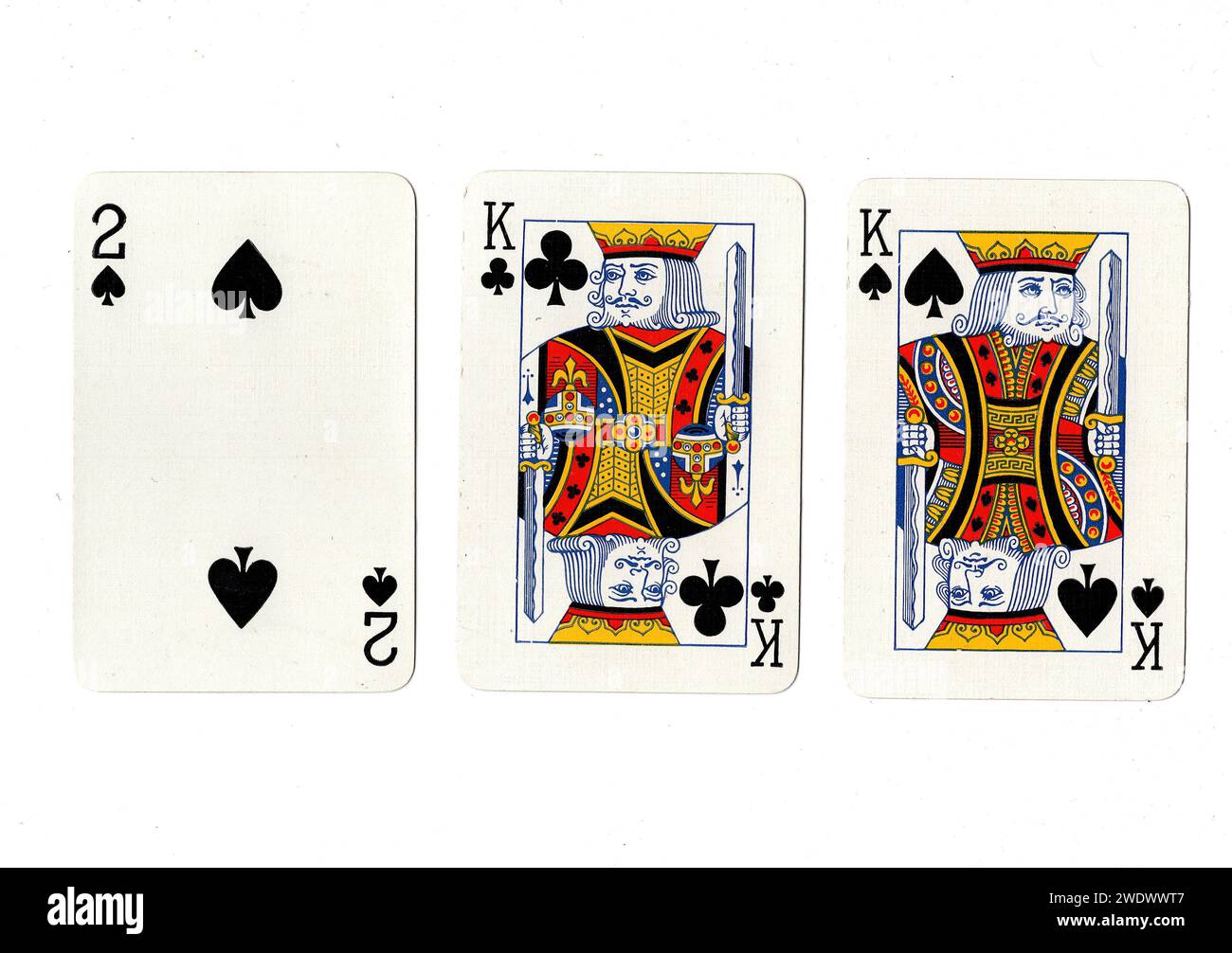 Vintage playing cards showing a pair of black kings and a black two