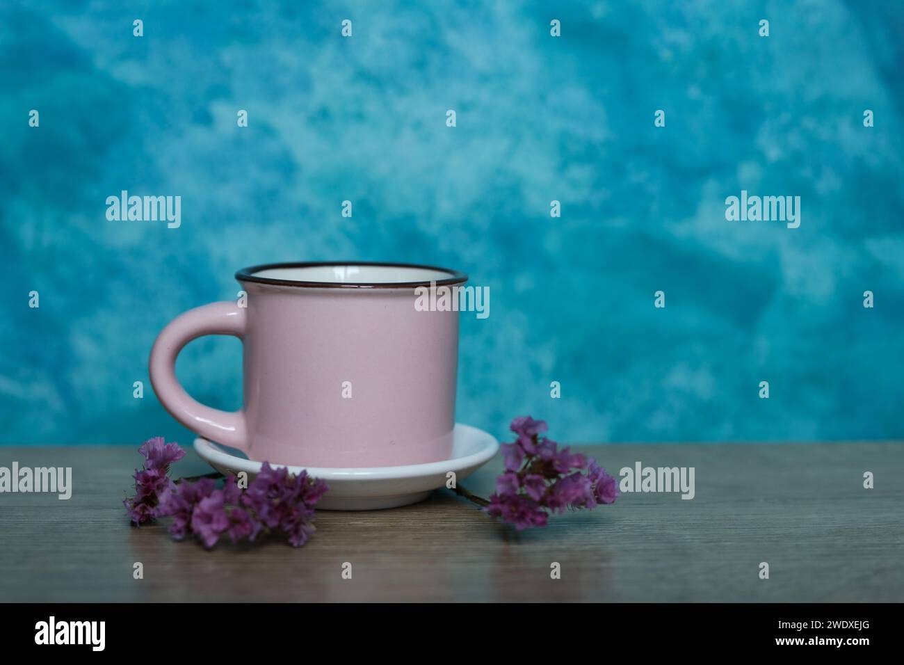 pink mug on a blue background. Minimalism. Stock Photo